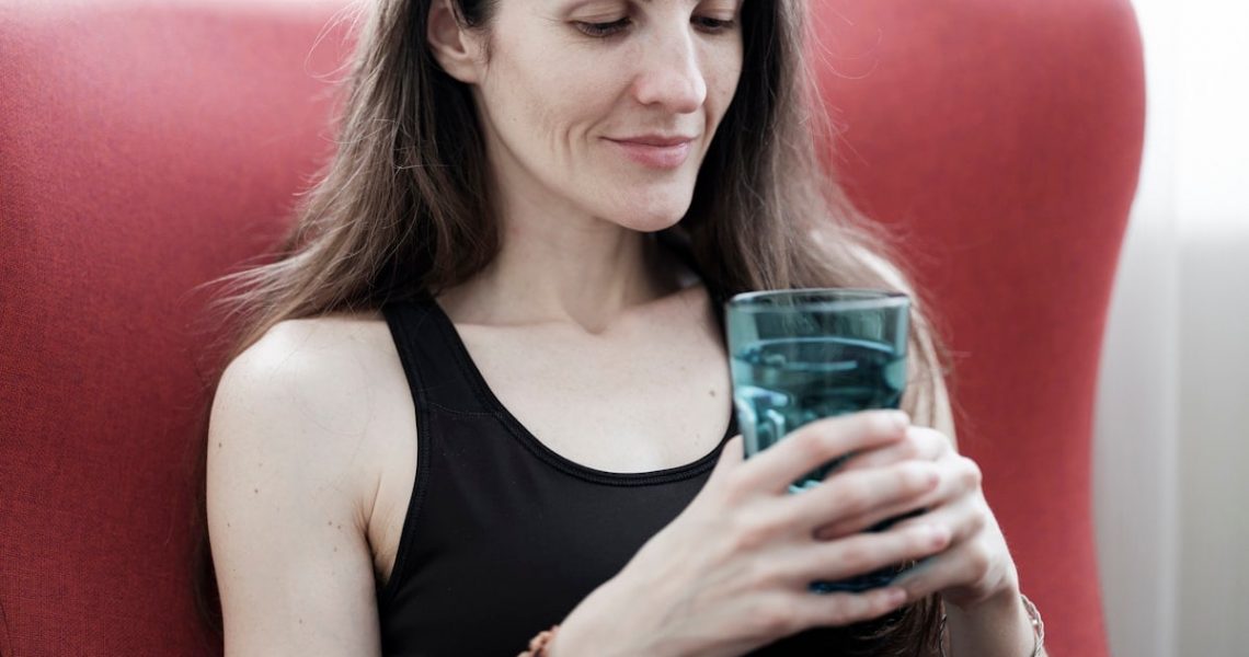 beautiful girl holding a glass of water